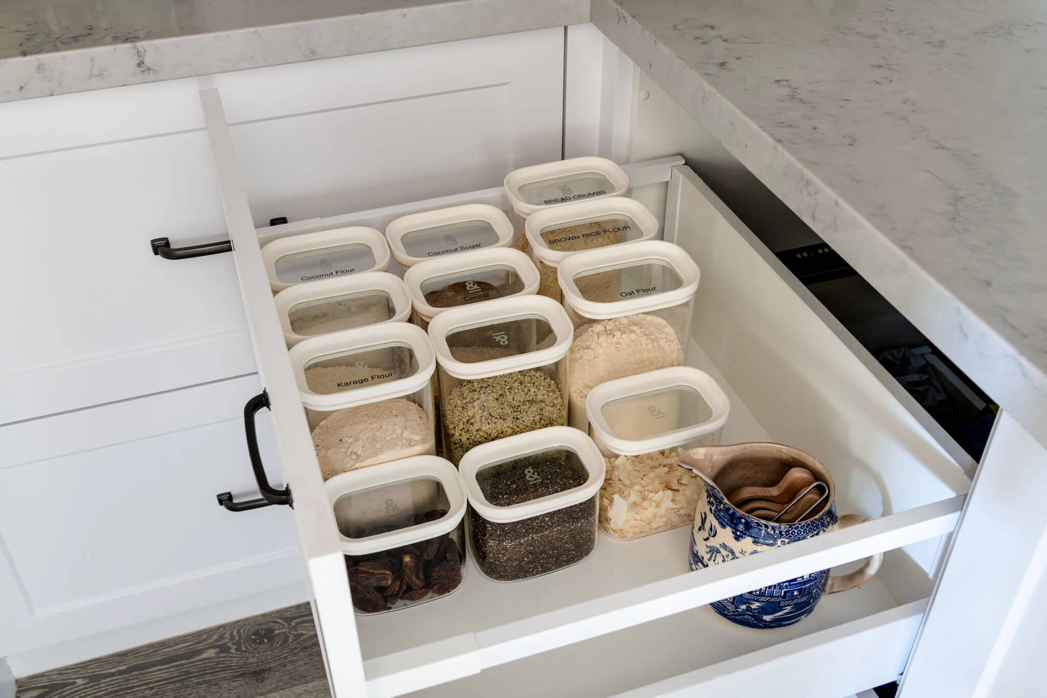 A kitchen drawer of clear labelled containers